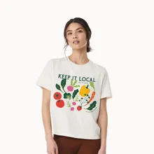 Model wearing a white Keep It Local boxy T-shirt