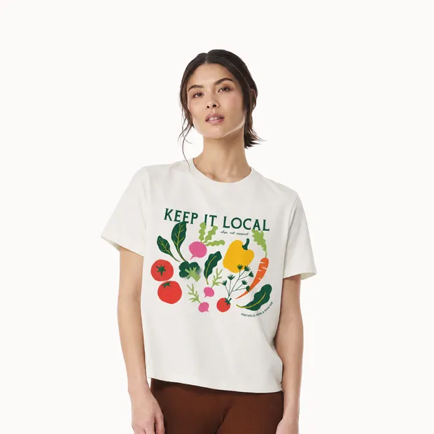 Model wearing a white Keep It Local boxy T-shirt