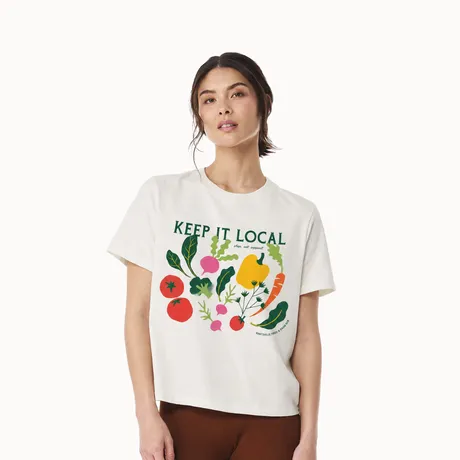 Model wearing a white Keep It Local boxy T-shirt