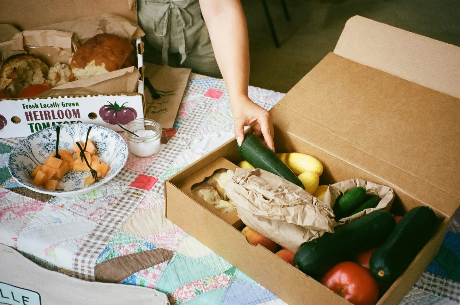 Fresh locally grown produce including heirloom tomatoes, herbs, and seasonal vegetables from Hub farms